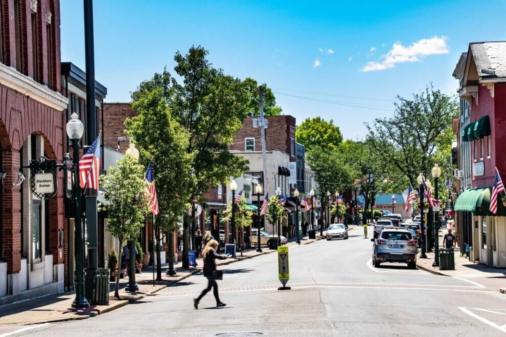 Downtown Sewickley lined with shops, trees and American flags